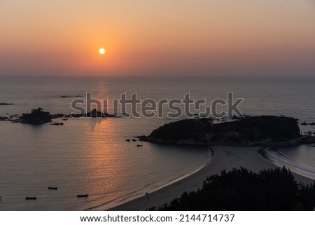 Aerial view of the Dong'shan Island coastline with peaceful ocean at sunrise. Shot in Fujian Province, China.