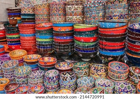Colorful east ceramic plates and bowls with national pattern in colorful colors. National tableware on Traditional market in Dubai, UAEz. High quality photo