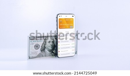 E banking concept. Mobile phone with internet online bank app. Pig bank with hundred dollar bill on white background. Online wallet save money Royalty-Free Stock Photo #2144725049