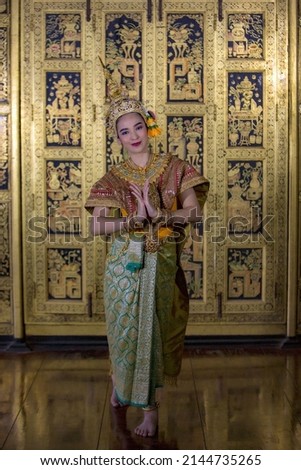 A young Thai girl dressed in a beautiful pantomime dressed in the character of Nang Srida dancing in a Thai pantomime performance; Khon is traditional dance drama art of Thai classical masked