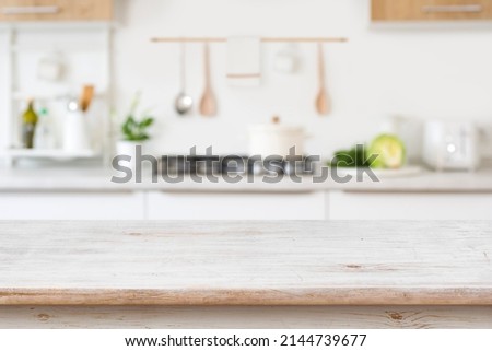 Blurred kitchen background with wooden table top for in front
