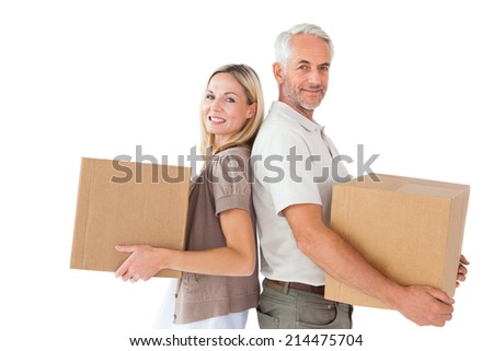 Happy couple holding moving boxes on white background