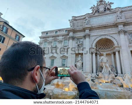 Picture in picture. Photographer Immortala The Trevi Fountain in Rome at the first night lights