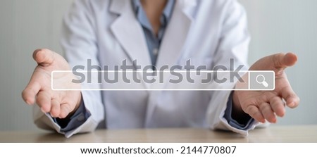 Asian woman doctor open the palm of the hand and on hand have searching browsing internet bar, Concept of Searching Browsing Internet Data Information Networking for medical and healthcare
