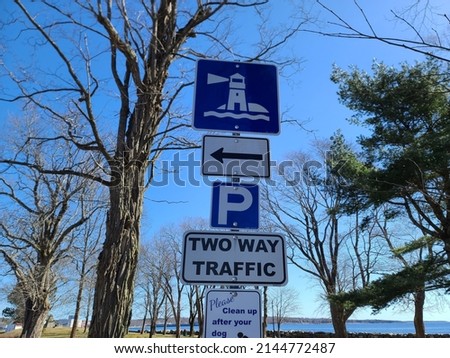 A post with multiple traffic signs attached to it.