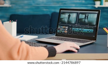 Content creator editing video montage on film production software, using laptop to learn for online class course. Student working on movie making development, creating multimedia footage. Royalty-Free Stock Photo #2144786897
