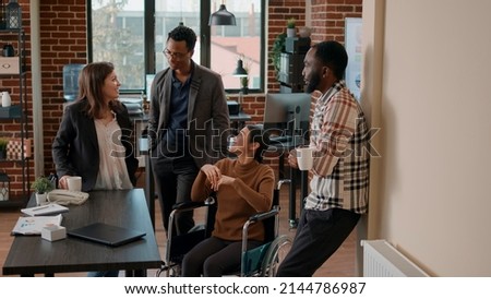 Diverse group of people laughing and having fun on work break in business office, meeting and talking about company growth. Colleagues feeling happy and celebrating work achievement. Royalty-Free Stock Photo #2144786987