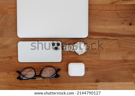 set of modern man gadgets on brown table. laptop, phone, watch, headphones. business. High quality photo