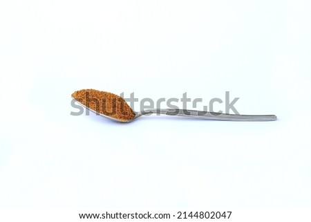 A tea spoon full of coconut sugar isolated on white background