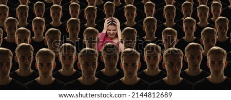 Fear, anger. Top view of grey crowd of identical people with same emotions and one different young girl. Diversity, stand out from the crowd concept. Unique among faceless, not like everyone else. Royalty-Free Stock Photo #2144812689