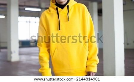 poster close up details of oversized yellow hoodie  at male.fashion and wear concept. trendн warm oversize wear at man.space for text and logo.close up details of oversize wear.horizontal banner wear