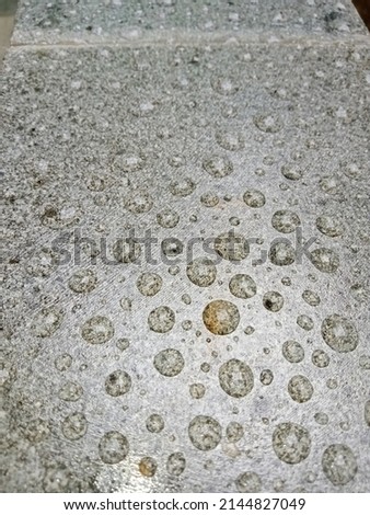 Remnants of rainwater left on the surface of natural stone