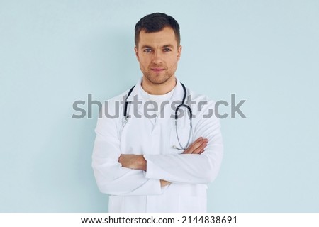Doctor in uniform standing in the studio.