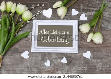 	Birthday Card: Frame with the lettering Alles Liebe zum Geburtstag with flowers with hearts.
Alles Liebe zum Geburtstag translated means happy birthday.