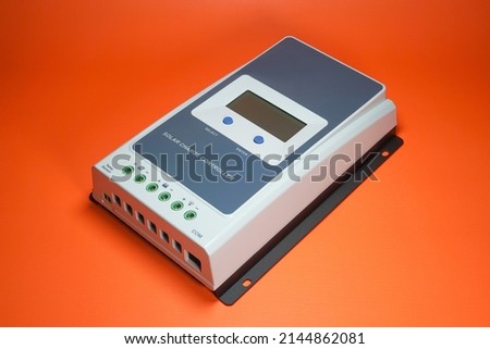 Solar charge controller for solar panel or solar electric energy, orange background isolated Royalty-Free Stock Photo #2144862081