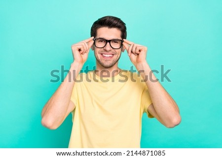 Photo of optimistic brunet guy wear eyewear yellow t-shirt isolated on turquoise color background Royalty-Free Stock Photo #2144871085