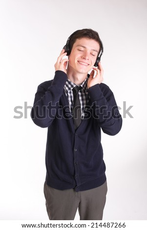 Handsome man in shirt listening to music in studio