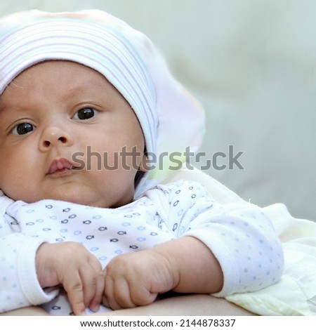 baby looking with big eyes just after having a good sleep in bed stock photos  