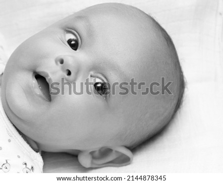 baby looking with big eyes just after having a good sleep in bed stock photos 