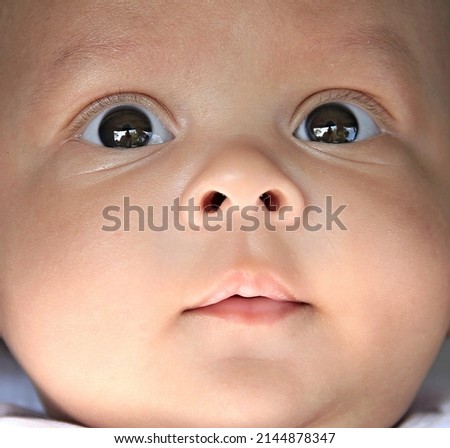 baby looking with big eyes just after having a good sleep in bed stock photos