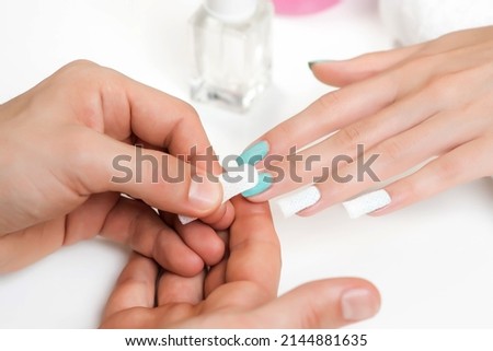 The process of removing or dissolving the old nail polish coating using foil, as well as covering the nails with new fresh nail gel polish using an ultraviolet lamp during the manicure procedure.