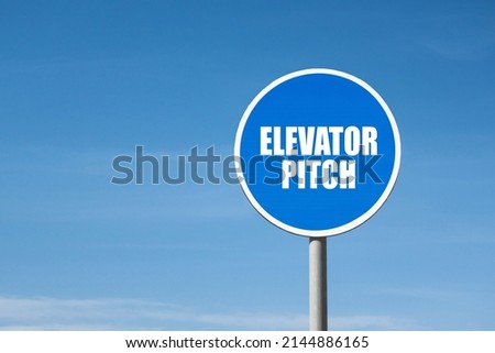 'Elevator pitch' sign in round blue frame. Clear sky is on background