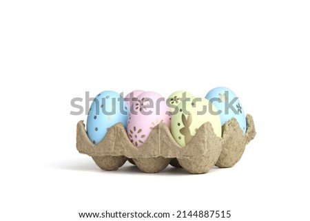Colored Easter eggs in the tray. White background. Space for copying. Minimalistic style.