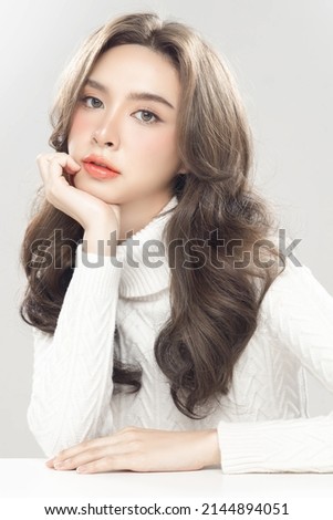 Beautiful young asian woman with clean fresh skin on grey background. Female model wearing white turtleneck Long sleeves Face care, Facial treatment, Cosmetology, beauty and spa, women portrait. Royalty-Free Stock Photo #2144894051