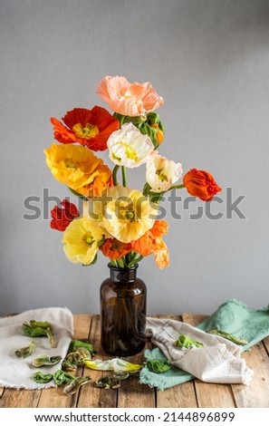 Colorful poppies in a brown glass vase, bouquet with Icelandic poppies in different colors