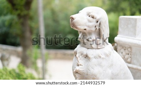 White dog statue in Sintra, Portugal. Stone dog sculpture Royalty-Free Stock Photo #2144932579