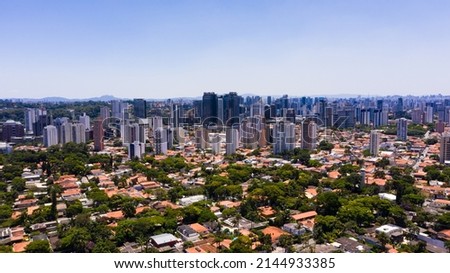 Aerial image of neighborhood of houses with buildings in the background. South zone of the city of sao paulo during the day