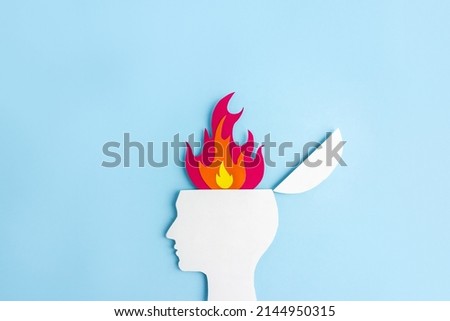 Cardboard application of the silhouette of human head and  flame. Сoncept of psychological and emotional burnout. Сopy space