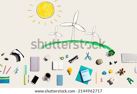 Windmills theme with collection of electronic gadgets and office supplies