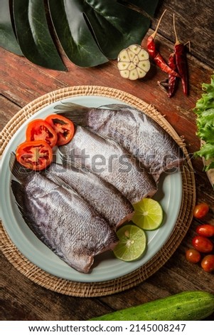 Fresh fish on the table garnished with vegetables
