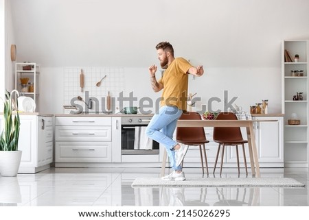 Cool young man dancing at home
