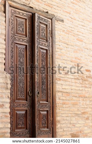 Carved doors made of natural wood. In the style of Central Asia.