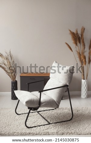Comfortable easy chair in a modern trendy home interior in pastel natural colors. High quality photo