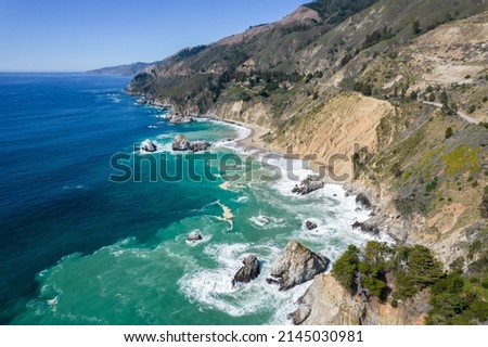 Aerial view of the beautiful coastline around Big Sur in central California. The ocean shows turquoise color. Shot on a viewpoint on Highway One.