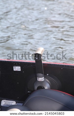 Throttle control for outboard motor. And button for lifting and lowering engine. Royalty-Free Stock Photo #2145045803