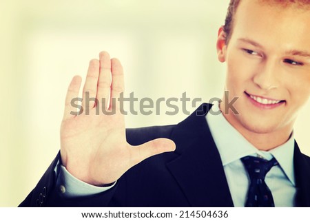 Business man pressing an abstract touchscreen button
