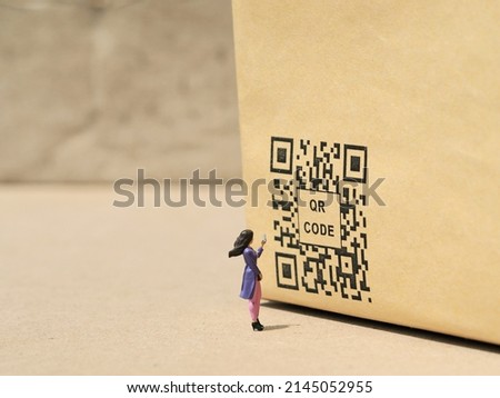 QR Code conceptual design on the brown table. Background is blurred.