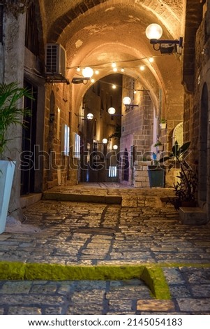 Night. The picturesque alleys of Old Jaffa. Evening lights illuminate the stone pavement. Old Jaffa - one of the most ancient cities of the world. Concept active, informative and photo of tourism