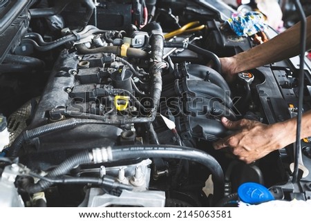 Intake manifold replacement in garage service shop. Royalty-Free Stock Photo #2145063581