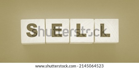 Wooden cubes with word sell on the dark background. Shopping concept.