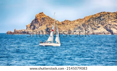 Incredible view of sailboat sailing near the cliffs of  Santa Teresa Gallura. Popular travel destination of Mediterranean sea. Location: Santa Teresa Gallura, Province of Sassari, Sardinia, Italy Royalty-Free Stock Photo #2145079083