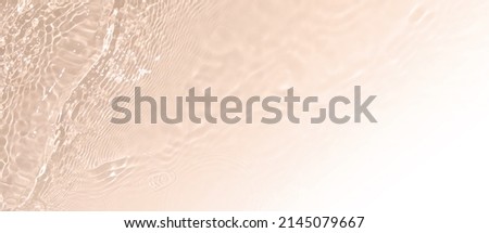 Abstract summer banner background Transparent beige clear water texture with ripples and splashes. Water waves copy space with white gradient, top view. Cosmetics moisturizer micellar toner emulsion Royalty-Free Stock Photo #2145079667