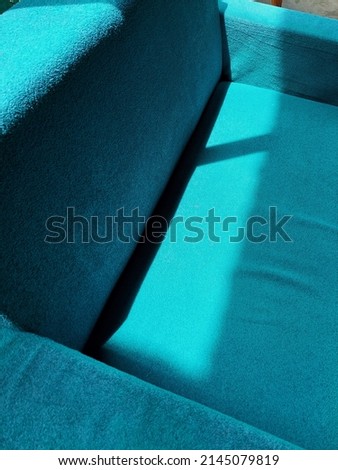 blue sofa in a room in the sun