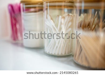 Containers with cotton swabs, tweezers, and brushes for styling eyebrows, accessories for the master of makeup and eyebrows. High quality photo