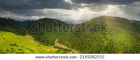 Wide-angle panoramic shot of beautiful meadows, hills and trees in Synevyrska glade next to Synevyr lake. Majestic and wonderful landscapes of the Carpathian mountains in Ukraine