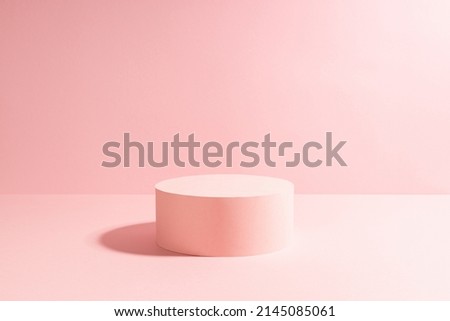 Elegant pastel pink circle single podium mockup in sunlight with shadow on soft light sunny background, copy space. Template scene for advertising, presentation cosmetic product or goods, design.